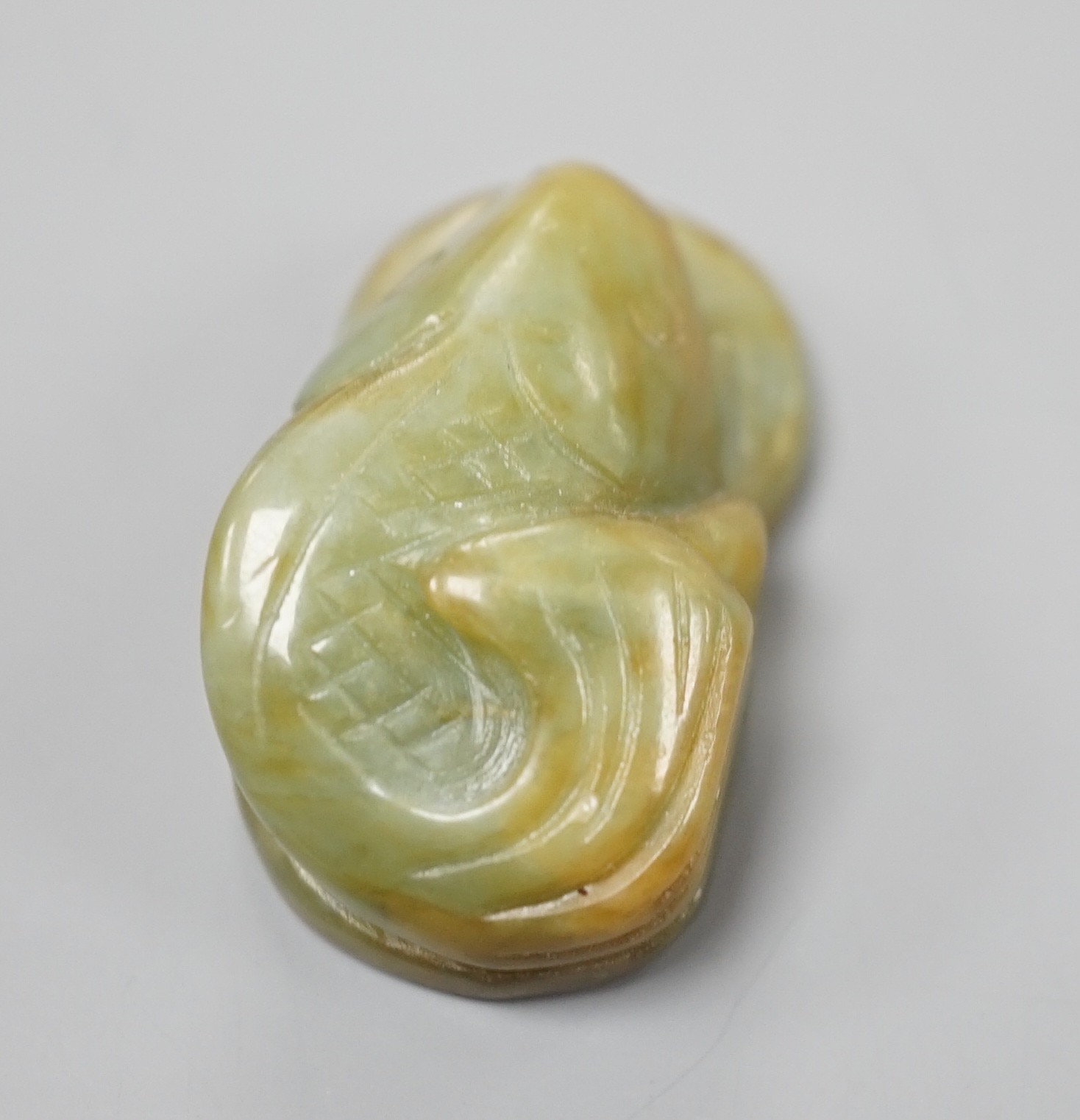 A Chinese jade fish and cash pendant, 3.4cm